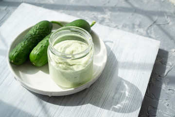 Two fresh green cucumbers and cheese toast for breakfast or moisturizing face mask