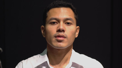 Close Up Portrait of a South East Asian Muslim man looking and smiling at camera with confidently