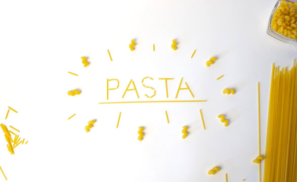 word "pasta" insde circle of pasta with spaghetty and  macaroni in bowl isolated white
