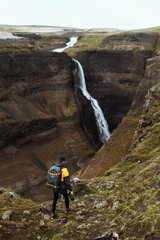 Traveler by a waterfall