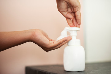 Woman using soap to clean hands and prevent coronavirus