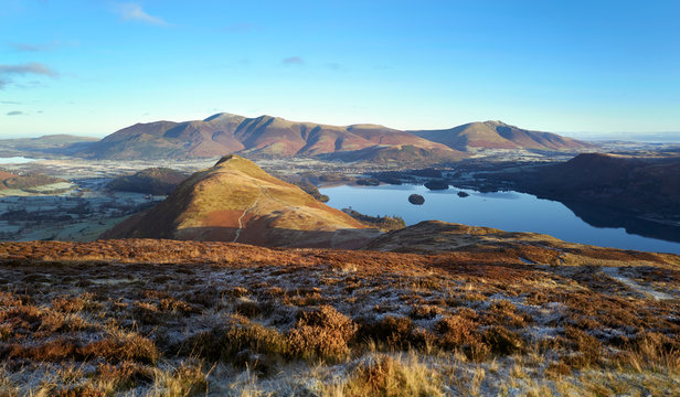 Sunrise over Derwent Water near Keswick with the summits of Cat Bells, Skiddaw and Blencathra in the distance from Maiden Moor on a cold winters morning in the Lak District.