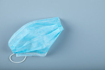 A blue tissue medical face mask isolated on blue 