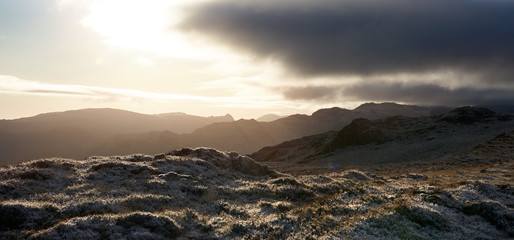 A cold winters sunrise over Borrowdale Fells, Glaramara in the distance, from near the summit of High Spy in the Lake District mountains in the UK.