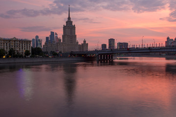 Fototapeta na wymiar Sunset on the river. Moscow Stalin-era skyscraper at sunset.