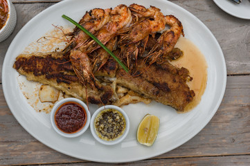 Seafood platter with grilled prawns and fish with sauces