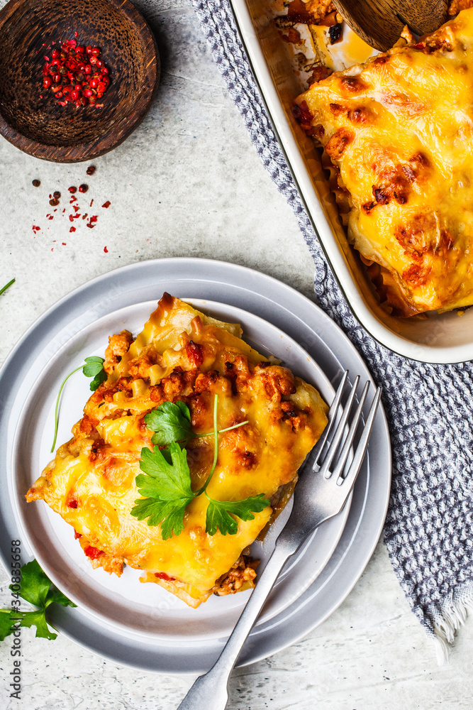 Wall mural classic meat lasagna with cheese on light gray background, top view. italian food concept.