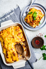 Classic meat lasagna with cheese on light gray background, top view. Italian food concept.