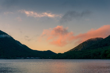 Mountain lake landscape at sunrise with colorful sky