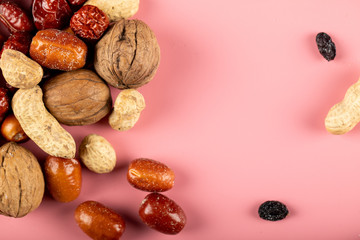 Traditional Novruz holiday nuts isolated on pink background including nuts and peanuts