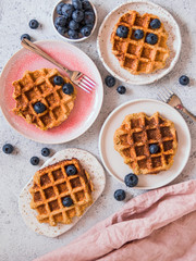 Easy healthy gluten free oat waffles with copy space. Plates with appetizing homemade waffles with...