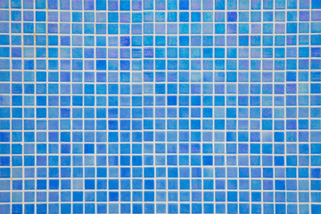 Ocean blue swimming pool mosaic tiles background, textured pool walls with copy space, a summer vacation inspiration, traveling to a tropical destination or relaxing holidays atmosphere concepts