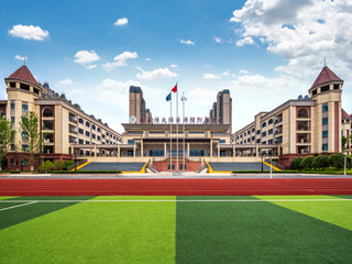 Fototapeta premium School football field and red running track