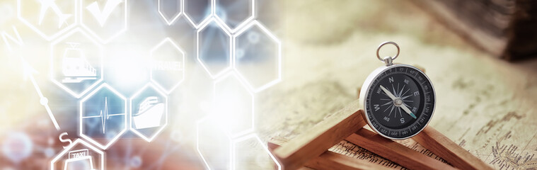 Travel and adventure search concept. Vintage aged map with a shabby book and compass. Shabby book...