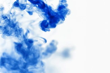 Puffs of paint in water. The dissolution of the dye in water. Water pollution. Concept art creativity.