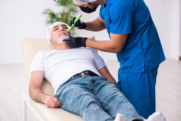 Old man visiting male doctor for plastic surgery