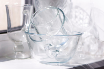 a set of glassware on the windowsill and reflection in bright sunlight