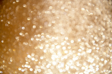 Gold glittering Christmas lights. Blurred abstract background