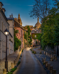 View of old street in quarter Montmartre in Paris, France. Cozy cityscape of Paris. Architecture and landmarks of Paris.
