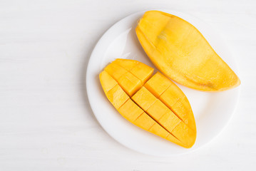 Ripe mango fruit sliced to cubes on white plate ready to eating, Tropical fruit, Thai mango (Nam Dok Mai), Top view