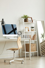 Vertical background image of empty home office workplace with wooden chair and modern computer on white desk, copy space