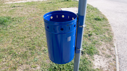 Public Blue Garbage Can. Empty garbage can in a park.