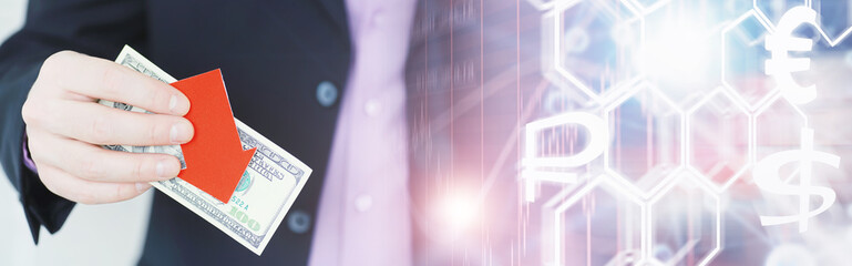 Financial crisis. Concept. Money bills in hand. Arrow symbol of the fall of the national currency. The change in the exchange rate between the Russian ruble and the US dollar.