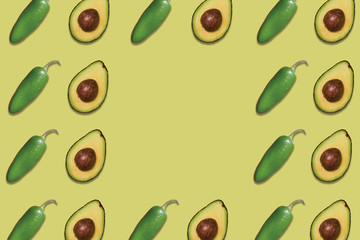patterns of delicious avocados and jalapeno peppers on green background