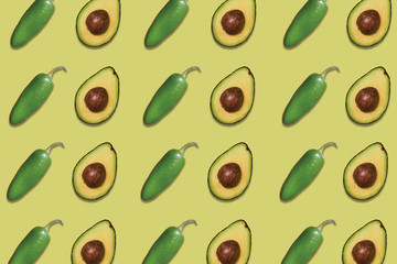 patterns of delicious avocados and jalapeno peppers on green background