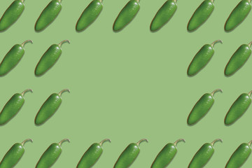patterns of delicious jalapeno peppers on green background