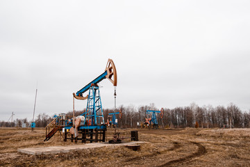Green Oil pump oil rig energy industrial machine for petroleum crude. oil crisis. Russia pumps oil pollution.