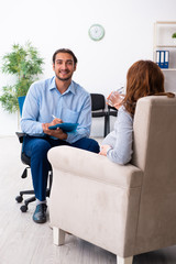 Pregnant woman visiting young male psychologist