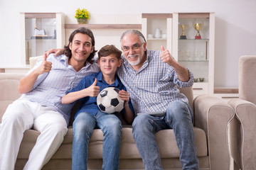 Boy and his father and his grandfother indoor