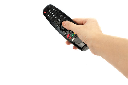 black remote control in hand isolated on white background