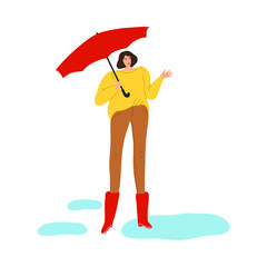 Woman in rubber boots with umbrella standing and enjoying rainy weather