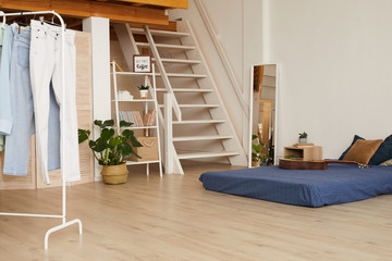 Background image of minimal bedroom interior with low bed and wooden flooring, copy space