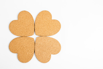 Shape with four hearts made from light brown textured cardboard, isolated on white with space for text
