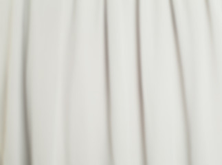 Blurred white silk smooth background. Abstract fabric