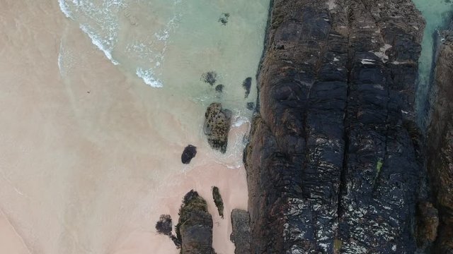 Beautiful Beach, turquoise water, in the north of Scotland. Sand, rocks and algue. Bird's eye view.