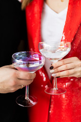Couple making a toast with their cocktails