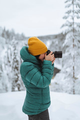 Fototapeta na wymiar Landscape photographer capturing a snowy Lapland