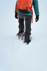 Naklejka premium Hiker wearing snowshoes on a trail in the snow