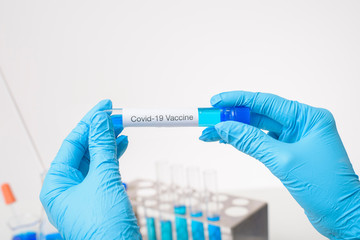 Close up doctor hand is holding covid-19  vaccine in laboratory
