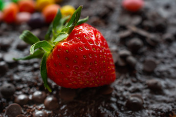 Closeup on fresh strawberry on chocolate background
