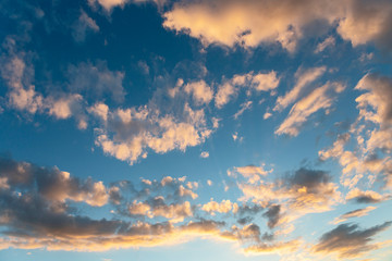 evening sky with clouds beautifully illuminated by the setting sun as a natural background