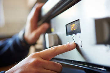 Man starting a microwave oven for cooking