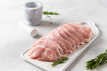 Raw pork meat. Fresh steaks on white board on white background. Side view, close up. Dieting, nutrition