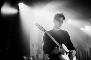 Guitarist playing electric guitar in a rock concert