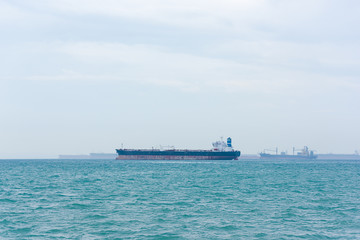 Cargo ships and oil tankers anchored offshore along the Singapore Straight, in Singapore