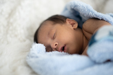 The baby is sleeping on a soft mattress
